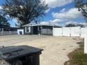 Single-story home features a spacious front yard and white picket fence, providing security and privacy at 4521 W Knox St, Tampa, FL 33614