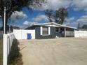 Single-story home with a well-maintained front yard and white picket fence, great curb appeal at 4521 W Knox St, Tampa, FL 33614