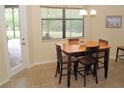 Bright breakfast nook with table and chairs, view of backyard patio at 20590 Granlago Dr, Venice, FL 34293