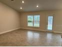 Bright and spacious living room with tile floors and access to backyard at 13106 Nusser Ave, Weeki Wachee, FL 34614