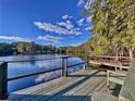 Enjoy breathtaking views from this lakeside deck, complete with a wooden bench at 8531 Bass Lake Dr, New Port Richey, FL 34654