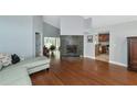 Bright living room with hardwood floors, fireplace, and sectional sofa at 1228 Cord Grass Ct, Wesley Chapel, FL 33543