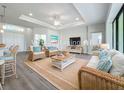 Bright living room featuring wicker furniture, light gray walls, and luxury vinyl flooring at 49 Marajo St, Punta Gorda, FL 33983