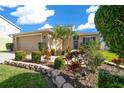 Two-story house with tan garage and well-manicured landscaping at 221 111 E St, Bradenton, FL 34212