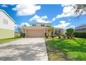 Two-story house with tan garage door, landscaping, and driveway at 221 111 E St, Bradenton, FL 34212