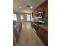 Modern kitchen featuring granite counters and stainless steel appliances at 4152 Banbury Cir, Parrish, FL 34219