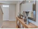 Light and bright entryway with console table, mirrors, and lamp at 30922 Wild Juniper Ct, Brooksville, FL 34602