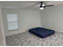 Spacious bedroom with ceiling fan, window blinds, and grey marble-look floors at 3619 Marco Dr, Tampa, FL 33614