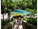 People enjoying a natural spring with clear water at 13213 Gulf Bay Ln, Spring Hill, FL 34609