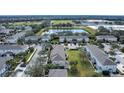 Aerial view of townhomes with gray roofs and green lawns at 6266 Triple Tail Ct # 103, Lakewood Ranch, FL 34202