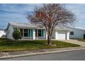 White single story home with teal shutters, and a tree in the front yard at 9205 40Th N Way # 5, Pinellas Park, FL 33782