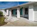 Front porch with white columns, teal shutters, and a white door at 9205 40Th N Way # 5, Pinellas Park, FL 33782