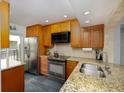 Kitchen with granite countertops, stainless steel appliances, and wood cabinets at 6372 Palma Del Mar S Blvd # Apt 307, St Petersburg, FL 33715