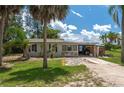 Charming single-story home with a spacious yard and mature palm trees at 1422 Bayshore Rd, Ruskin, FL 33570