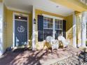 Front porch with white chairs and a gray door at 5516 Luminar Pointe Ln, Apollo Beach, FL 33572