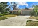 Brick house with a green garage door and a long driveway at 1813 Laurel Oak Dr, Valrico, FL 33596