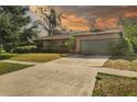 Brick house with a green garage door and a long driveway at 1813 Laurel Oak Dr, Valrico, FL 33596