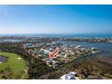 Aerial view showcasing waterfront property with canal access and golf course nearby at 10436 Raymond St, Englewood, FL 34224