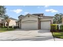 Lovely home featuring a three car garage and driveway at 5808 Falconcreek Pl, Lithia, FL 33547