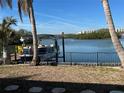 Private boat dock with a pontoon boat on the calm water at 1371 Sea Gull S Dr, St Petersburg, FL 33707