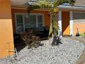 Inviting front porch with seating area and palm trees at 1371 Sea Gull S Dr, St Petersburg, FL 33707