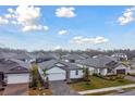 Community of single-Gathering homes with gray roofs and landscaped yards at 5213 Patano Loop, Palmetto, FL 34221