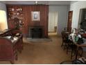 Living room with fireplace and wood paneling at 1073 Putnam Dr, Sarasota, FL 34234