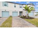 Townhouse exterior with light blue garage doors at 5410 Tripoli Dr, Palmetto, FL 34221