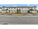 Five-unit townhome building with light blue garage doors and landscaping at 5414 Tripoli Dr, Palmetto, FL 34221