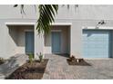 Two-unit townhome building with light blue doors and garage doors at 5414 Tripoli Dr, Palmetto, FL 34221