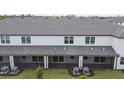 Rear view of townhouses showcasing screened patios and AC units at 5418 Tripoli Dr, Palmetto, FL 34221