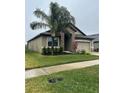 One-story house with stone accents and landscaping at 11854 Thicket Wood Dr, Riverview, FL 33579