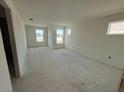 Spacious bedroom with large windows and wood-look flooring at 13719 Emerald Fields Dr, Hudson, FL 34667