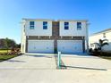 Two-story house with a two-car garage and stone accents at 13719 Emerald Fields Dr, Hudson, FL 34667