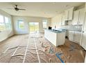 Open kitchen with white cabinets and an island at 13998 Emerald Fields Dr, Hudson, FL 34667