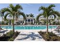 Resort-style pool with lounge chairs and palm trees at 18063 Cherished Loop, Bradenton, FL 34211