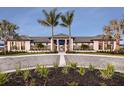 Community clubhouse with attractive landscaping and palm trees at 18079 Cherished Loop, Bradenton, FL 34211