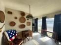 Bright dining area with wood desk, rocking chair, and decorative wall baskets at 2529 Ednor St, Port Charlotte, FL 33952