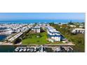 Bird's-eye view of waterfront condo community with boat slips and ocean access at 3806 Gulf Of Mexico Dr # C310, Longboat Key, FL 34228