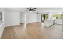 Bright and airy living room with light wood floors and kitchen island at 6628 Keystone Dr, Sarasota, FL 34231