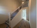 Elegant staircase with dark metal balusters leading to upper level at 7950 Chandler Lake Ct, Hudson, FL 34667