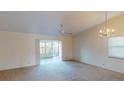 Bright living room with vaulted ceiling, carpet flooring, and access to a sunroom at 1710 Curry Ave # 42, Nokomis, FL 34275