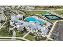 An aerial view of the community pool and recreation center, surrounded by palm trees and lush landscaping at 17150 Savory Mist Cir, Bradenton, FL 34211