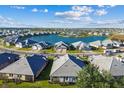 Aerial view of community homes surrounding central lake at 18024 Cherished Loop, Bradenton, FL 34211
