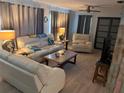 Comfortable living room featuring plush seating, a ceiling fan, and a TV for relaxation at 246 176Th E Ave, Redington Shores, FL 33708
