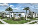 Front view of the clubhouse framed by palm trees, lush lawn, and manicured landscaping at 4719 Cassonade Cv, Bradenton, FL 34211