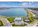 Breathtaking aerial view of a lakefront community featuring a pool, playground, and scenic walking trails at 7526 Backlight Ln, Sarasota, FL 34240