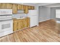 Kitchen with wood cabinets and white appliances at 7450 35Th N St # 1604, Pinellas Park, FL 33781
