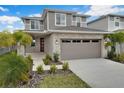 Two-story home with stone accents and a two-car garage at 5943 Jensen View Ave, Apollo Beach, FL 33572