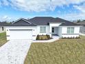 White house with dark gray roof and landscaping at 9585 Calumet Blvd, Port Charlotte, FL 33981